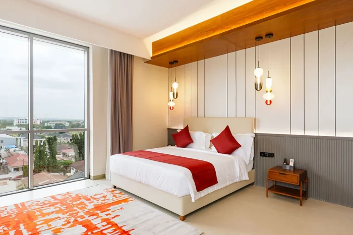 Deluxe Room guest accommodation with king bed at Abantu Hotel in Mikocheni, Dar es Salaam.