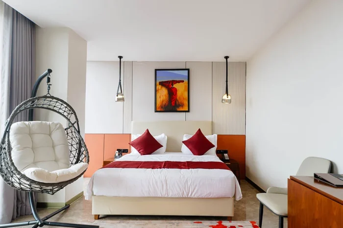 King-size bed with crisp white linens in the main Abantu Royal Room.