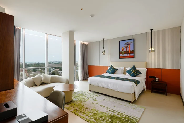 Suite living area and king bed at Abantu Hotel in Mikocheni, Dar es Salaam.