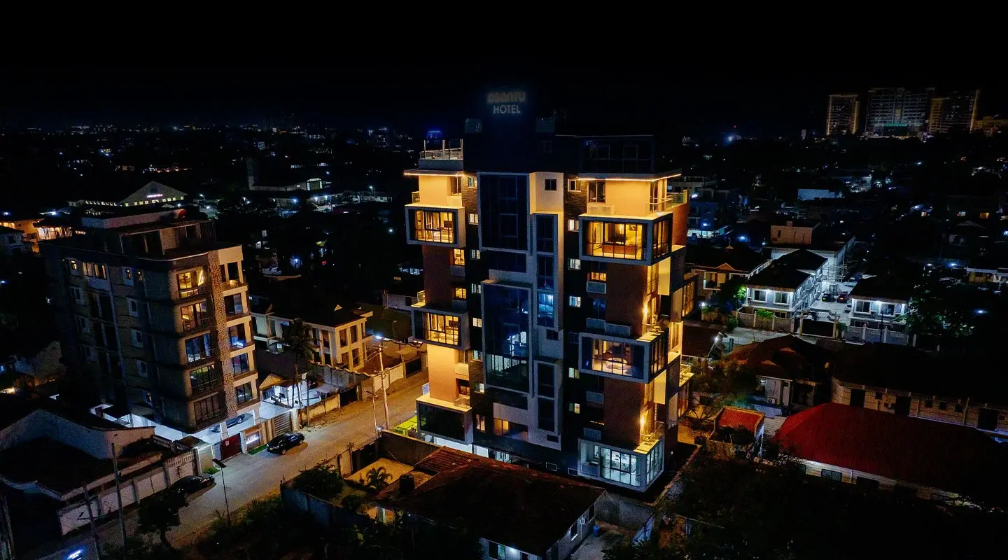Aerial night view of Abantu Hotel and the surrounding city skyline in Mikocheni, Dar es Salaam.